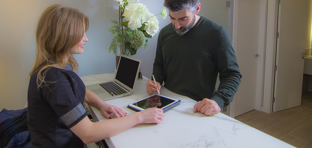 Frau und Mann zeichnen mit Stift auf einem Tablet